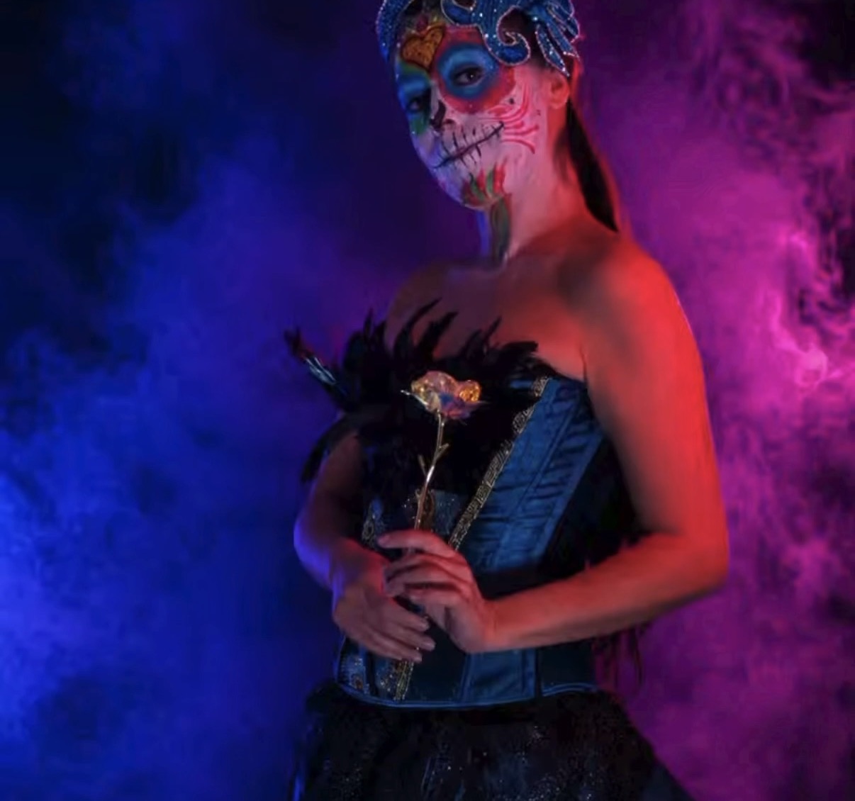 Side profile sugar skull with feathered rose in blue smoke