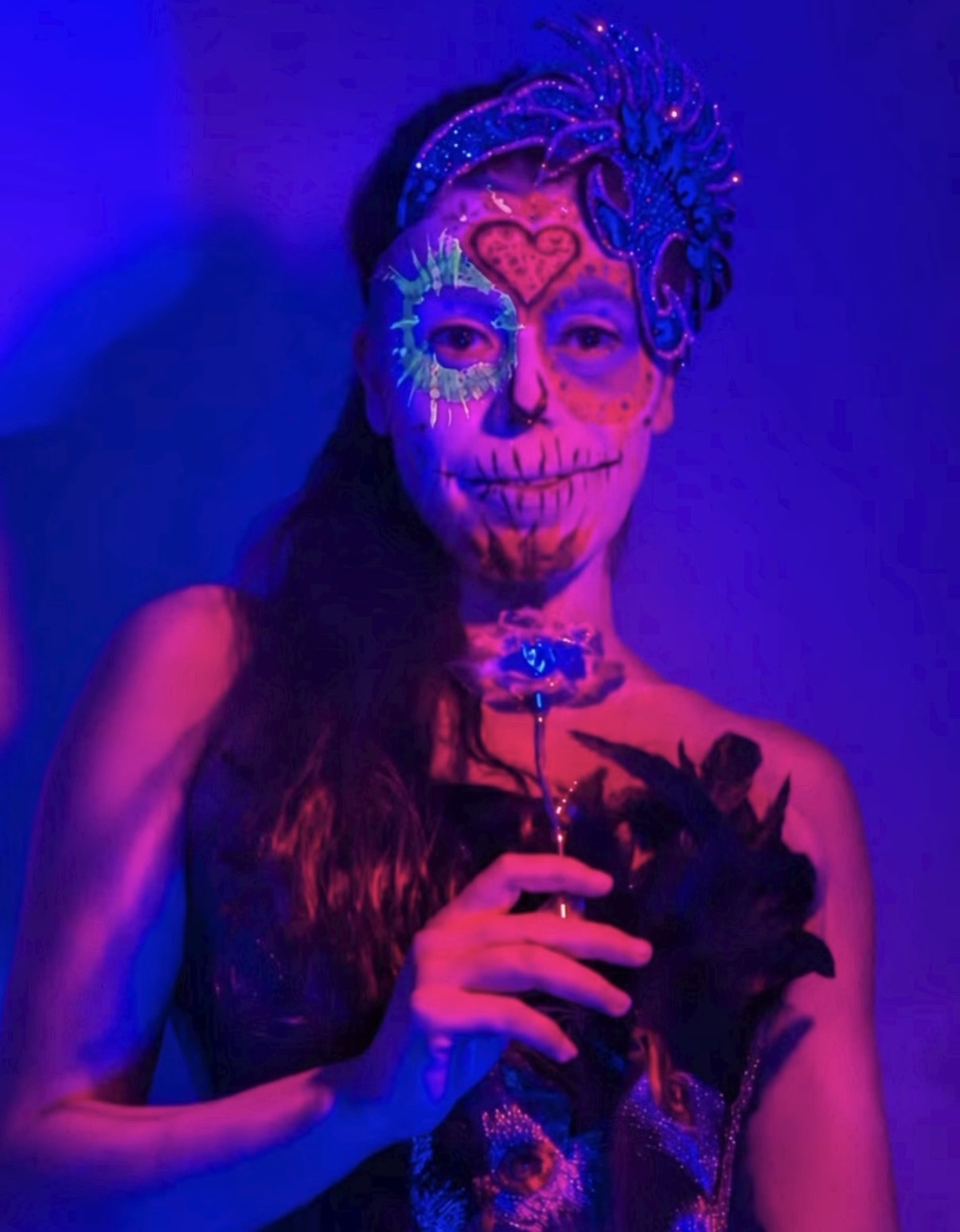 UV sugar skull close-up with blue feather headpiece