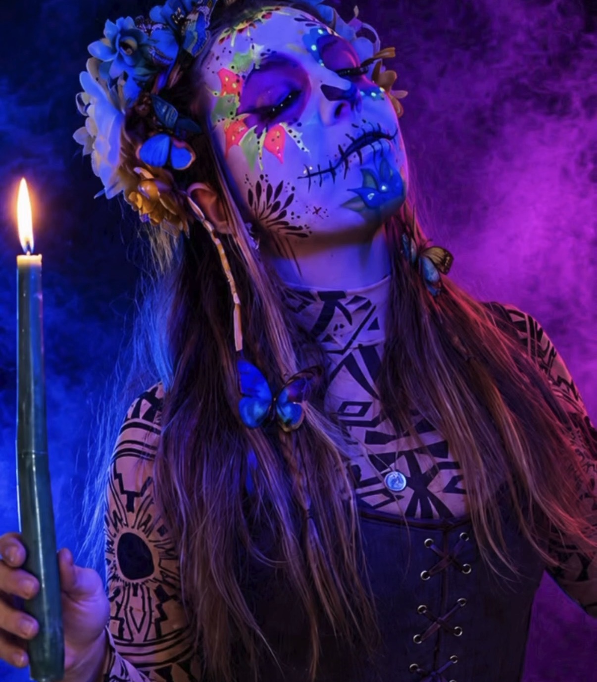 UV sugar skull holding a candle with butterfly crown